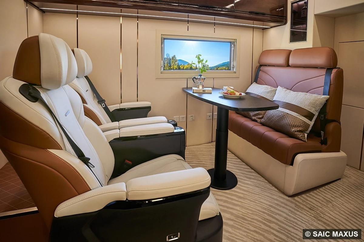 The upper level: first-class VIP seats, a three-person sofa and a dinette under a picture window.