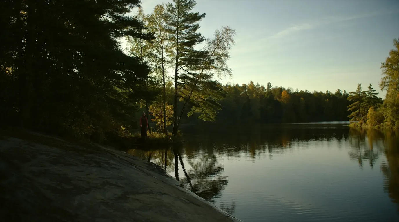 A Boundary Waters campsite on a low granite outcrop above a still lake with a fire grate, red pines behind and a canoe pulled up on the rock, northern Minnesota, ultrarealistic photograph representative of the region
