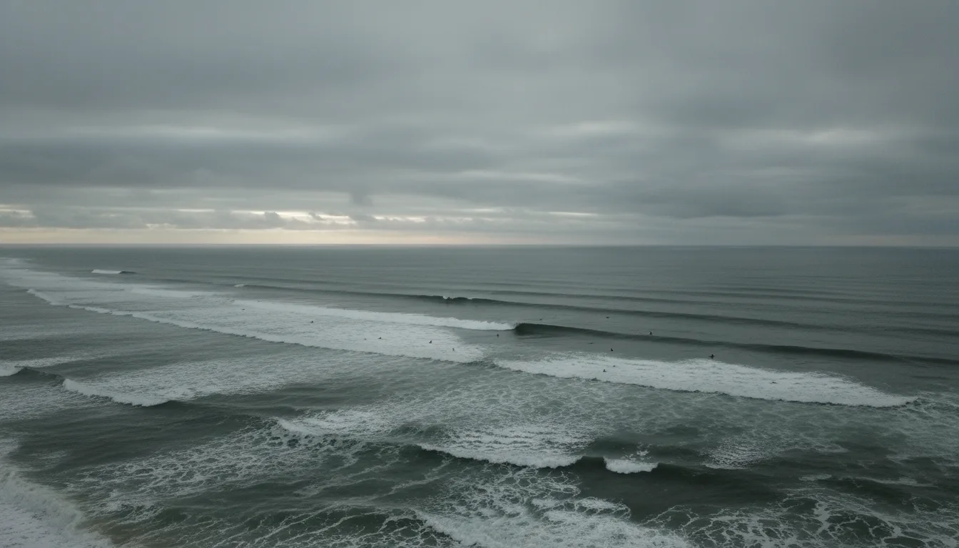 Surfers in full wetsuits walking a wide grey beach toward heavy Pacific swell under overcast sky, boards under arms, illustrative render in the series style