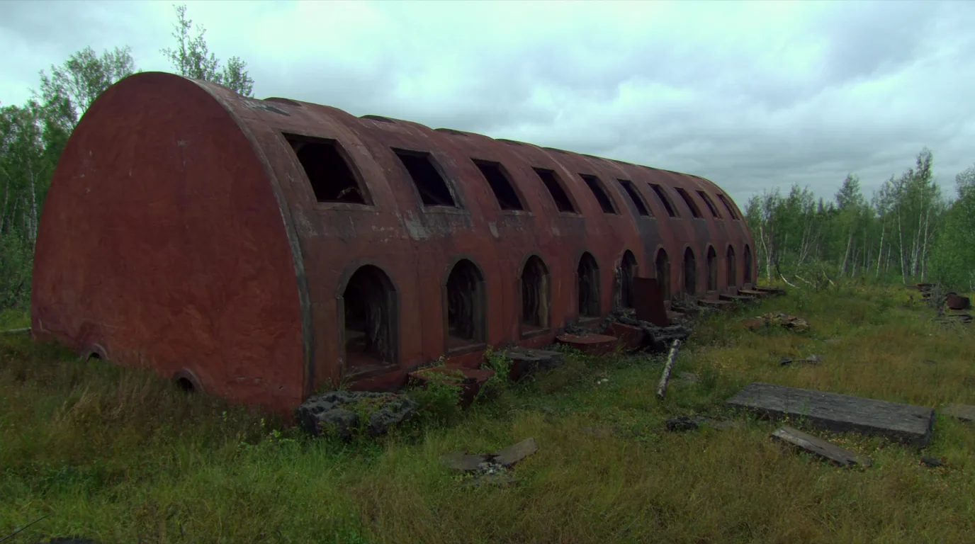 A roofless sandstone engine house from an abandoned copper mine standing among young birch regrowth, empty window openings and crumbling masonry, overgrown poor-rock piles nearby, Keweenaw Michigan, ultrarealistic photograph representative of the region